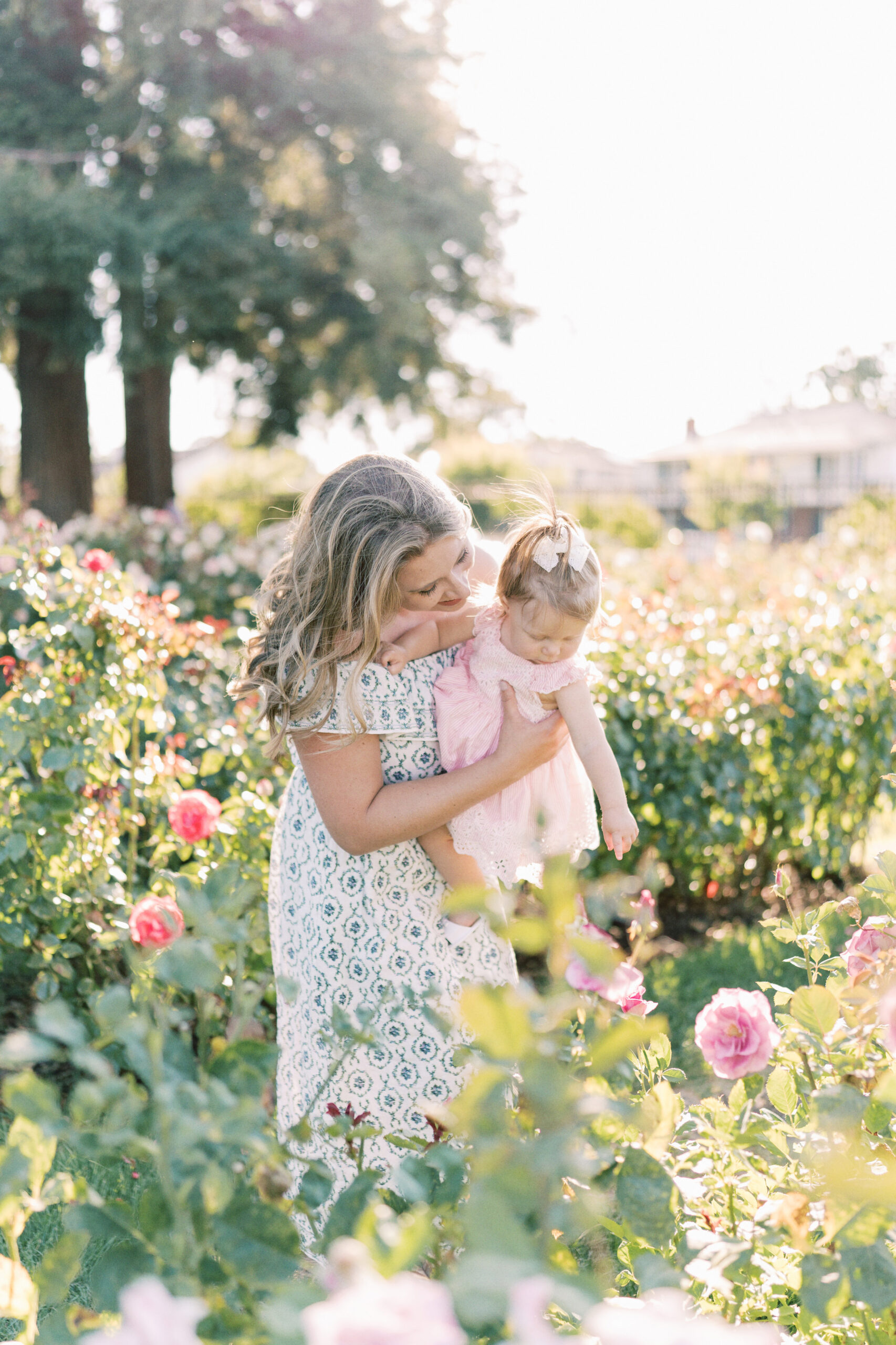 mom and daughter in the rose garden